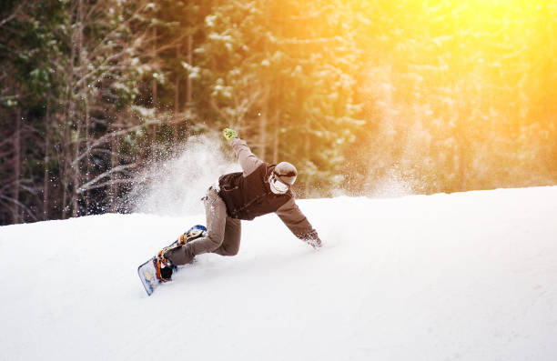 istock Snowboarder rides over fresh snow on the slope in winter 677776482