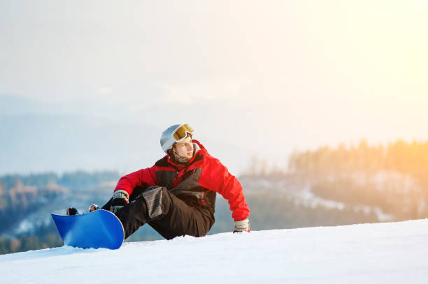 istock Male boarder on his snowboard at winer resort 677776580