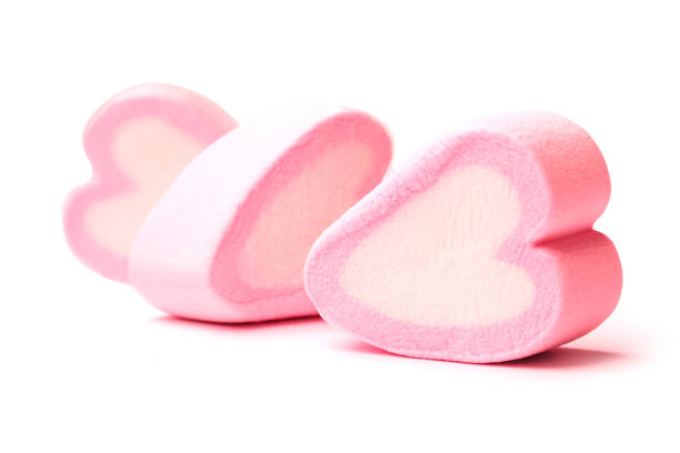 Pink heart shaped marshmallows isolated on white background
