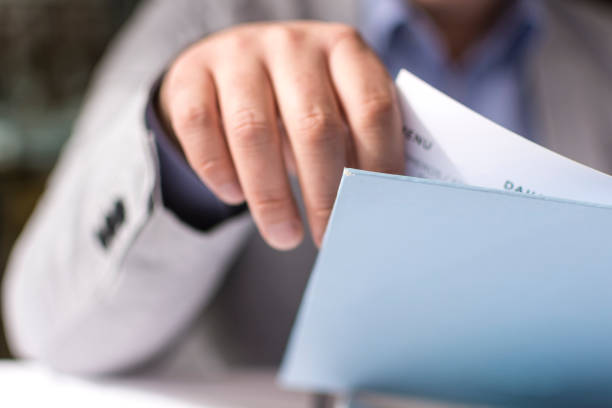 Male Hand Holding Restaurant Menu to Make Order for Lunch