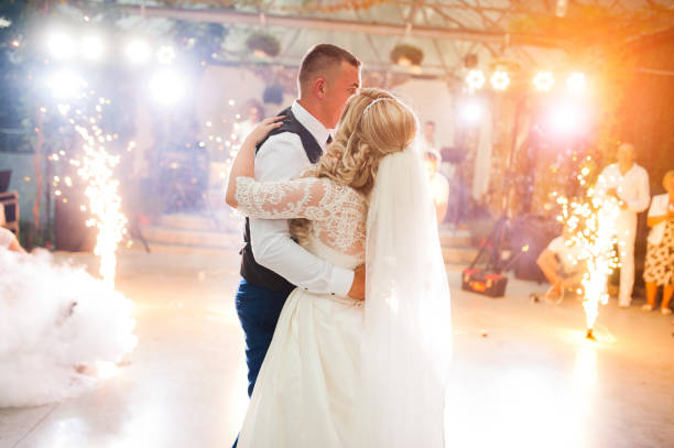Amazing first wedding dance of newlyweds at heavy smoke and fireworks. Amazing first wedding dance of newlyweds at heavy smoke and fireworks. wedding party stock pictures, royalty-free photos & images