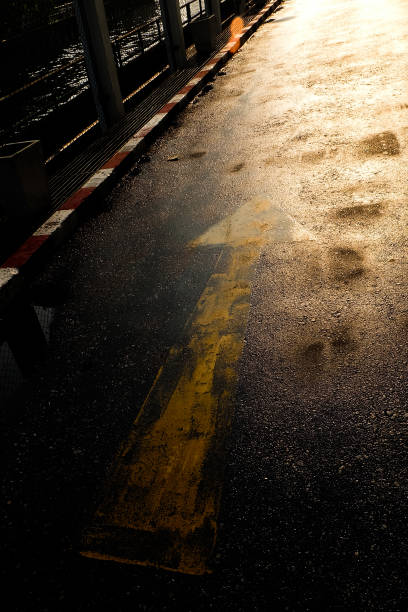 istock arrow sign on the road after raining 677789910