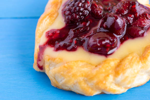 istock Vanilla Cream and Fruit Berry Puff Pastry Dessert on Blue Background 677799260
