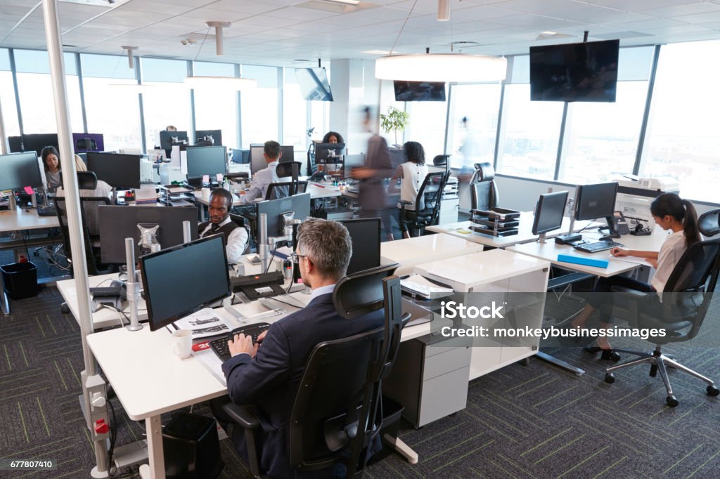 Interior Of Busy Modern Open Plan Office With Staff Office Stock Photo