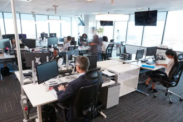 Photo of Interior Of Busy Modern Open Plan Office With Staff