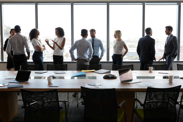 istock Businesspeople Stand And Chat Before Meeting In Boardroom 677807852