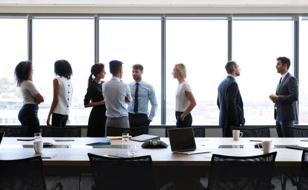 istock Businesspeople Stand And Chat Before Meeting In Boardroom 677808292