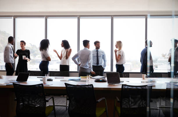 istock Businesspeople Stand And Chat Before Meeting In Boardroom 677808492