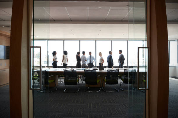 istock Businesspeople Stand And Chat Before Meeting In Boardroom 677808784