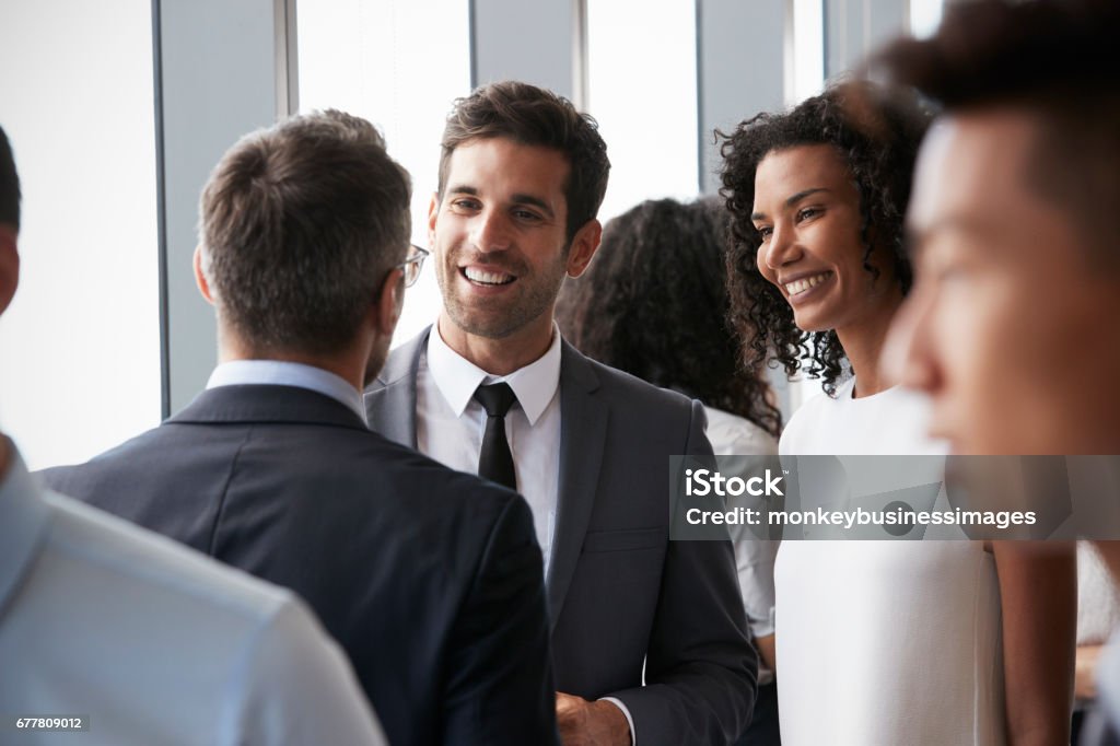 Group Of Businesspeople Having Informal Office Meeting Networking Stock Photo