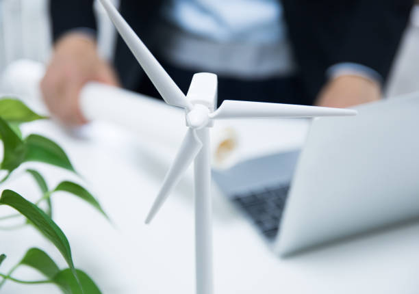 istock Businessman working with model wind turbines 677811214