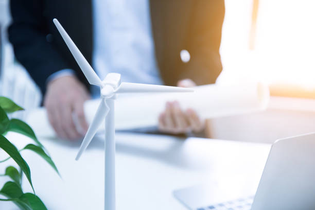 istock Businessman working with model wind turbines 677811890