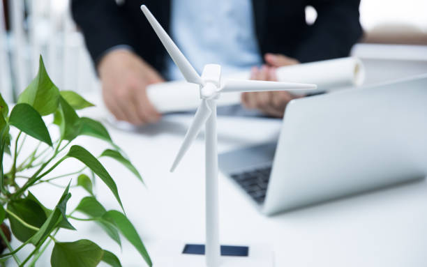 istock Businessman working with model wind turbines 677812098