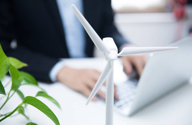 istock Businessman working with model wind turbines 677812394