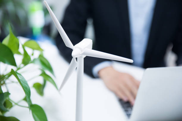 istock Businessman working with model wind turbines 677812734