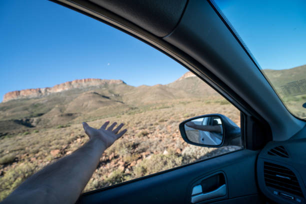 istock Man stretching out hand from window car 677813000