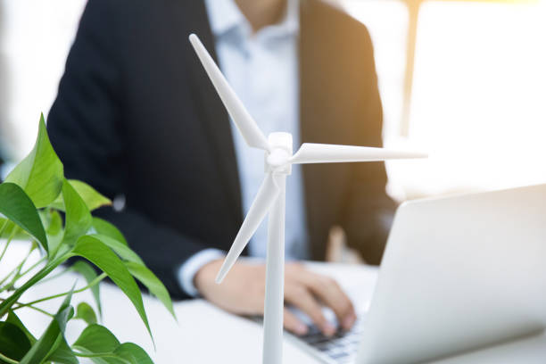 istock Businessman working with model wind turbines 677813162