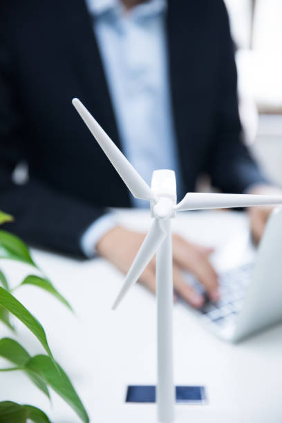 istock Businessman working with model wind turbines 677813484
