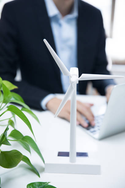 istock Businessman working with model wind turbines 677818426