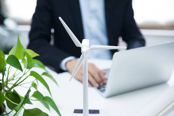 istock Businessman working with model wind turbines 677823698