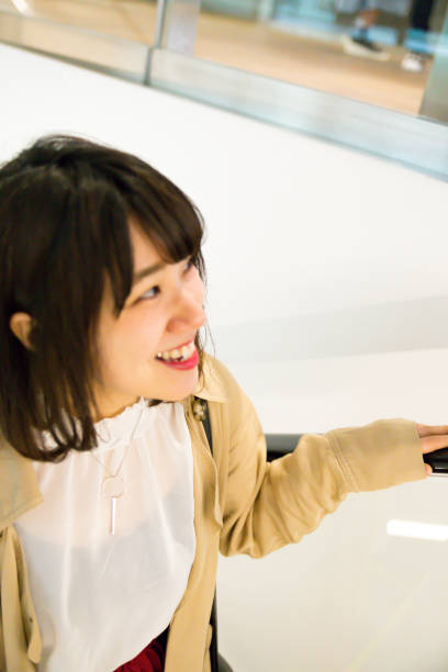 istock Woman up escalator 677824026