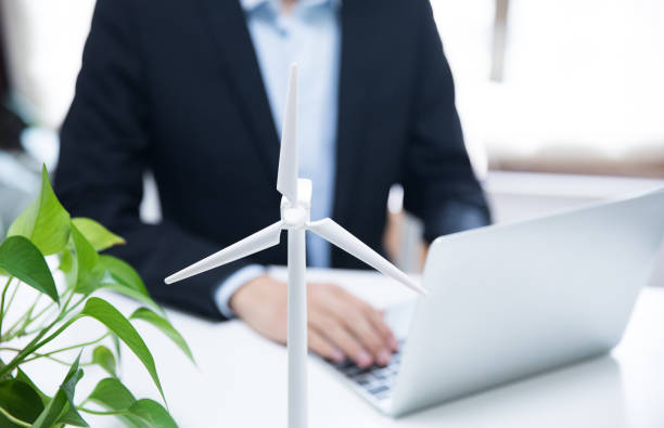 istock Businessman working with model wind turbines 677824248