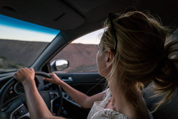 istock One young female driving at sunrise 677824686