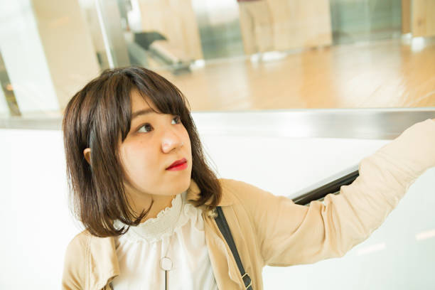 istock Woman up escalator 677826758