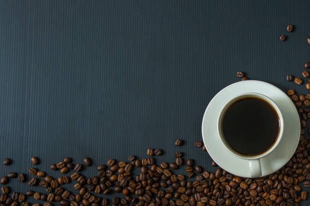 istock Coffee cup and coffee beans on black background. Top view. 677844742