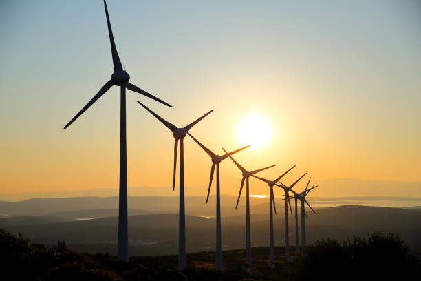 Wind Turbines at Sunset the wind turbines silhouette generating electricity in the sunset landscape alternative energy scenics farm stock pictures, royalty-free photos & images