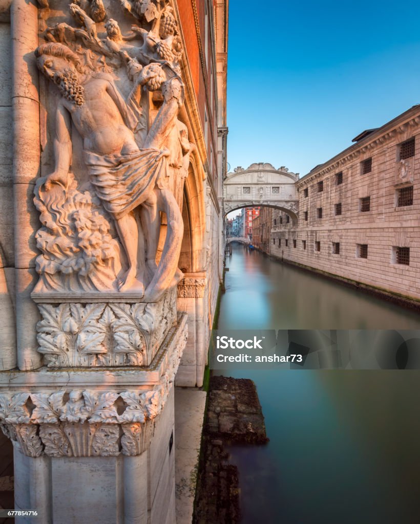 Drunkenness of Noah Sculpture and Bridge of Sighs at Sunrise, Venice, Italy Architecture Stock Photo