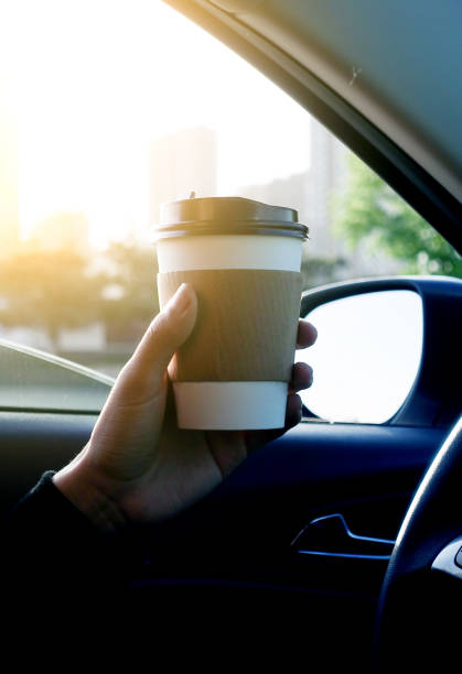 istock Man holding coffee in car 677868402