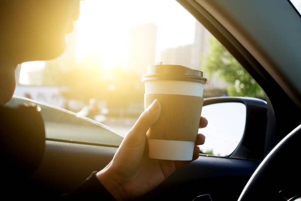 istock Man holding coffee in car 677870878