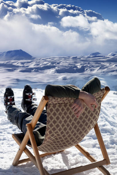 skier at winter mountains resting on sun-lounger - ski resort winter sport apres ski ski slope imagens e fotografias de stock