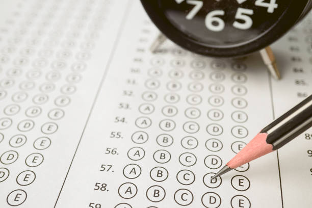 istock answer sheet , alarm clock and pencil for education concept 677875694