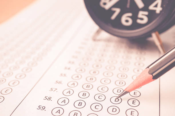 istock answer sheet , alarm clock and pencil for education concept 677875820