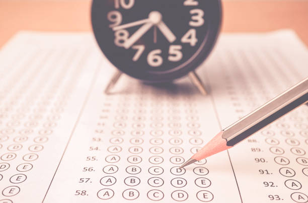 istock answer sheet , alarm clock and pencil for education concept 677875906