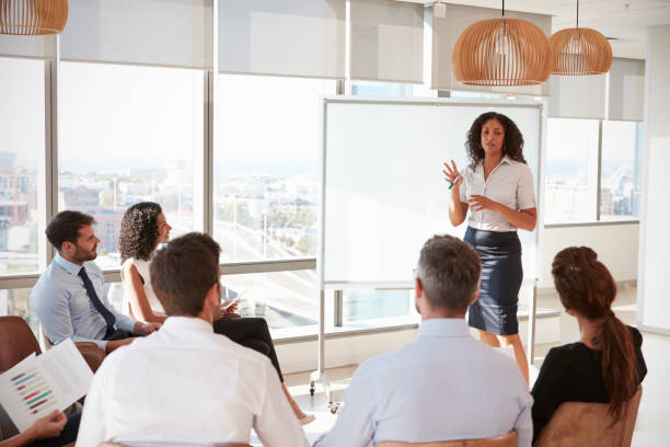 istock Businesswoman Making Presentation Shot Through Doorway 677893280