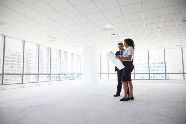 istock Businesspeople Meeting To Look At Plans In Empty Office 677893376