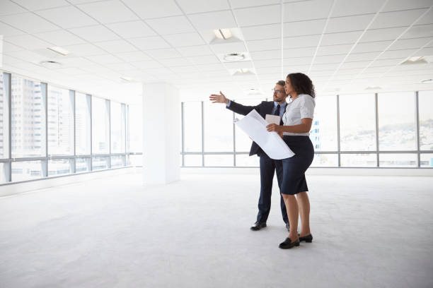istock Businesspeople Meeting To Look At Plans In Empty Office 677893382