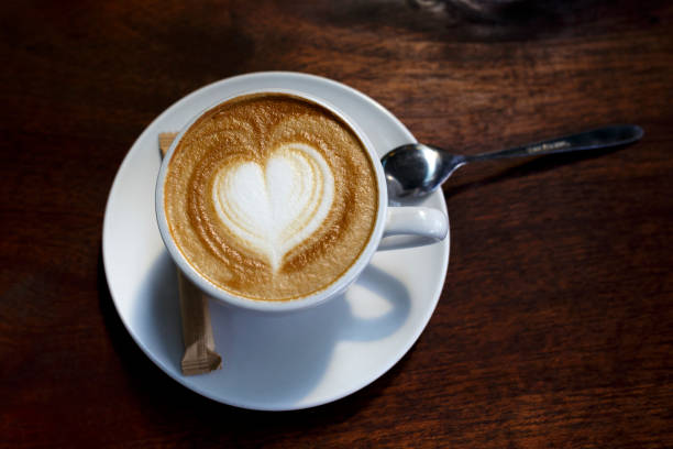 istock The cup hot capuchino on the wooden table background. 677917858