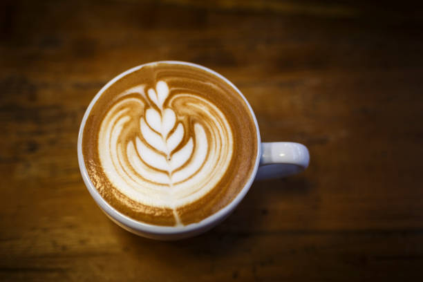 istock The cup hot capuchino on the wooden table background. 677918106