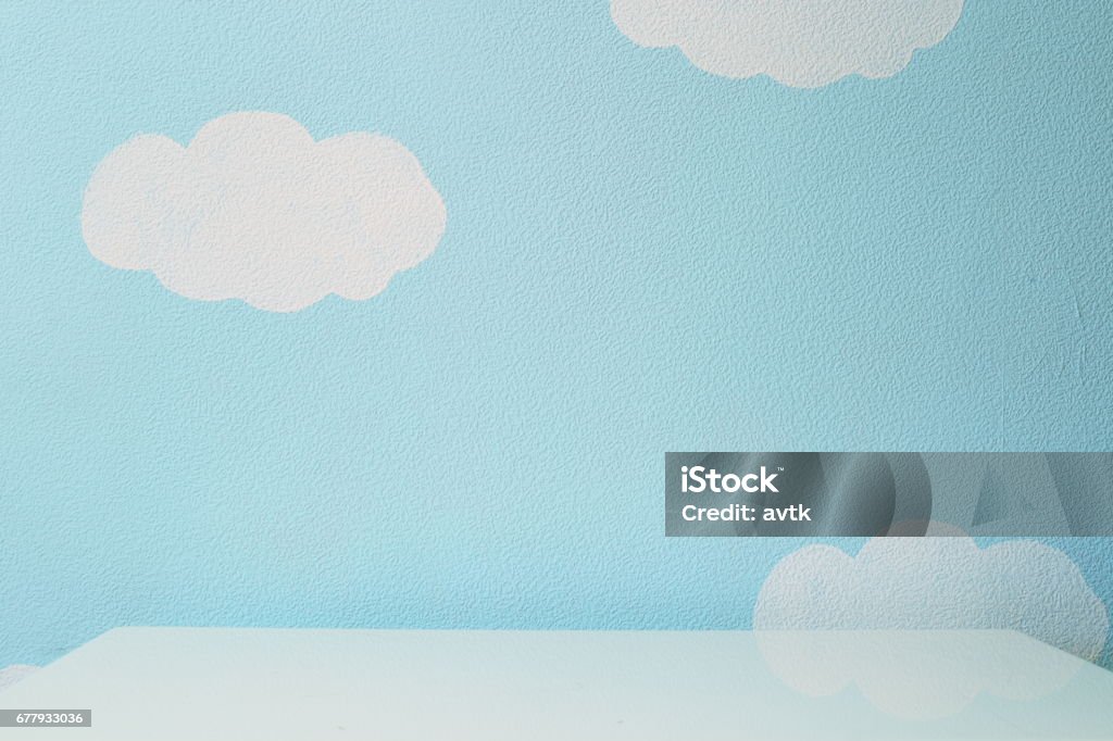 sky blue wall and an empty table Childhood Stock Photo