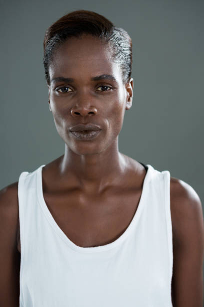 istock Androgynous man in white waist posing against grey background 677945032