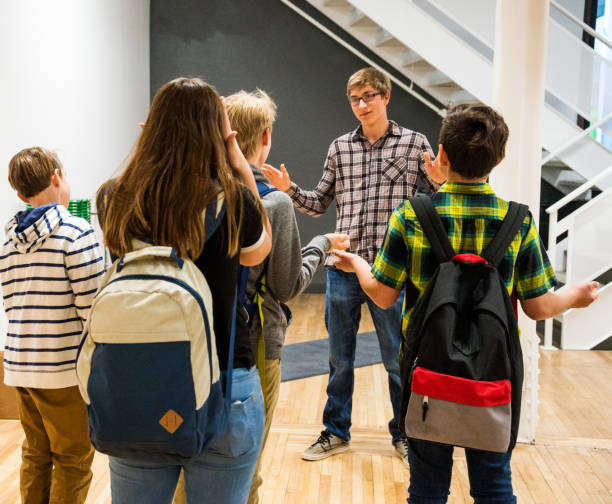 istock School-aged children being prevented from leaving a store 677952332