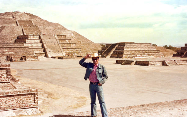 A man standing on a mexican arqueological site Pyramid of the Magician in Uxmal, in the Yucatan peninsula in Mexico, Mayan Arqueological Site. cowboy photos stock pictures, royalty-free photos & images