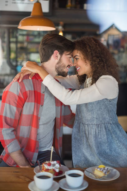 istock Happy young couple embracing in pub 677975930