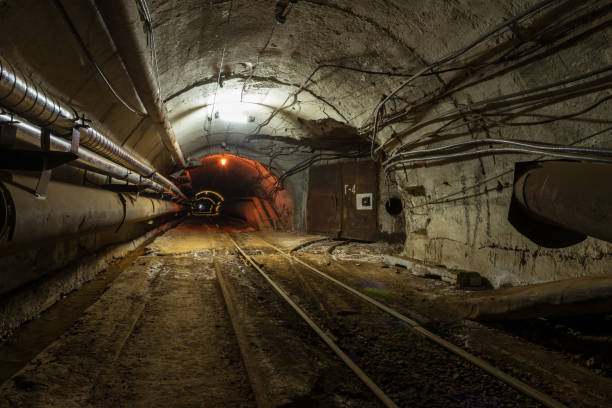 istock A tunnel with pipes and a railroad lighted by a dull light 677977886