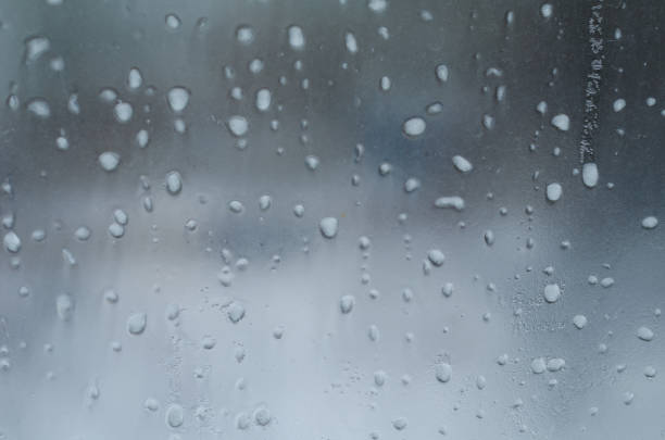 istock Rain drops and frozen water on window glass background 677980998