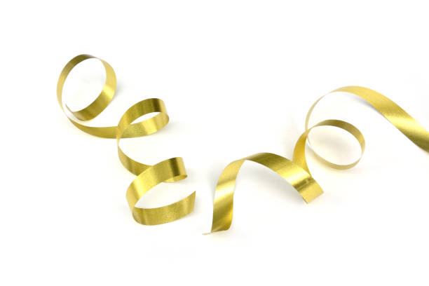 the spiral golden ribbon isolated on white background. the spiral golden ribbon isolated on white background. streamer stock pictures, royalty-free photos & images